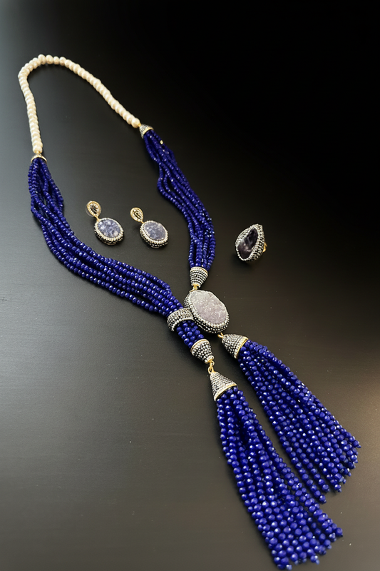 Siyah arka plan üzerinde mavi kristal boncuk püsküllü 3'lü takı seti: kolye, küpe ve yüzük