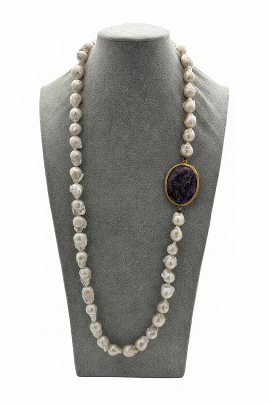 Beyaz arka plan üzerinde gerçek barok inci ve ametist taşlı uzun kolye